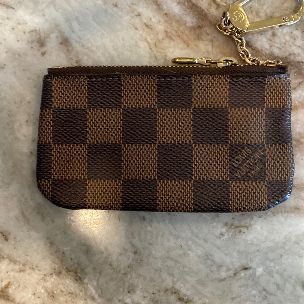 Like new key pouch scratches on zipper as seen